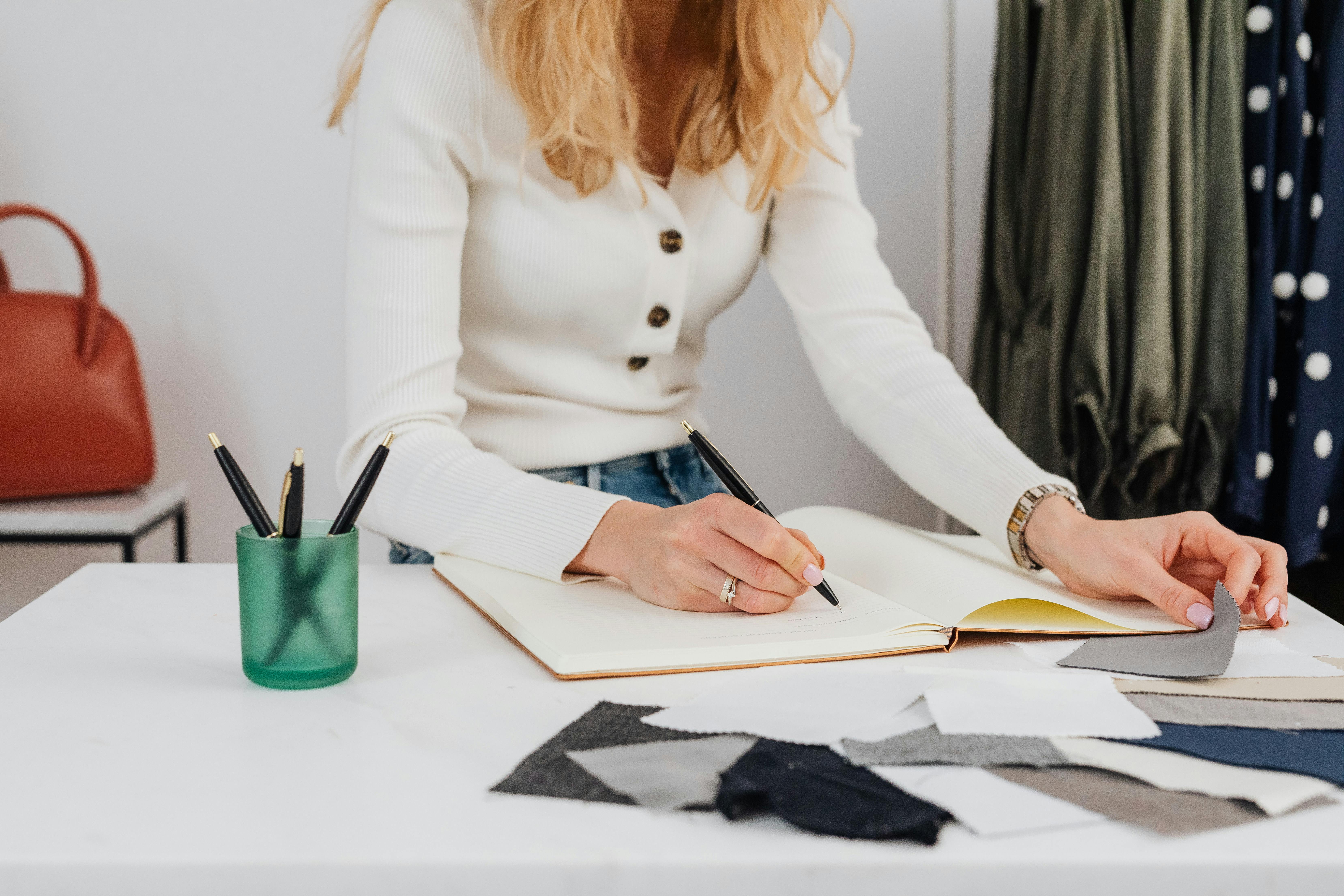 Person writing notes for a business or marketing plan