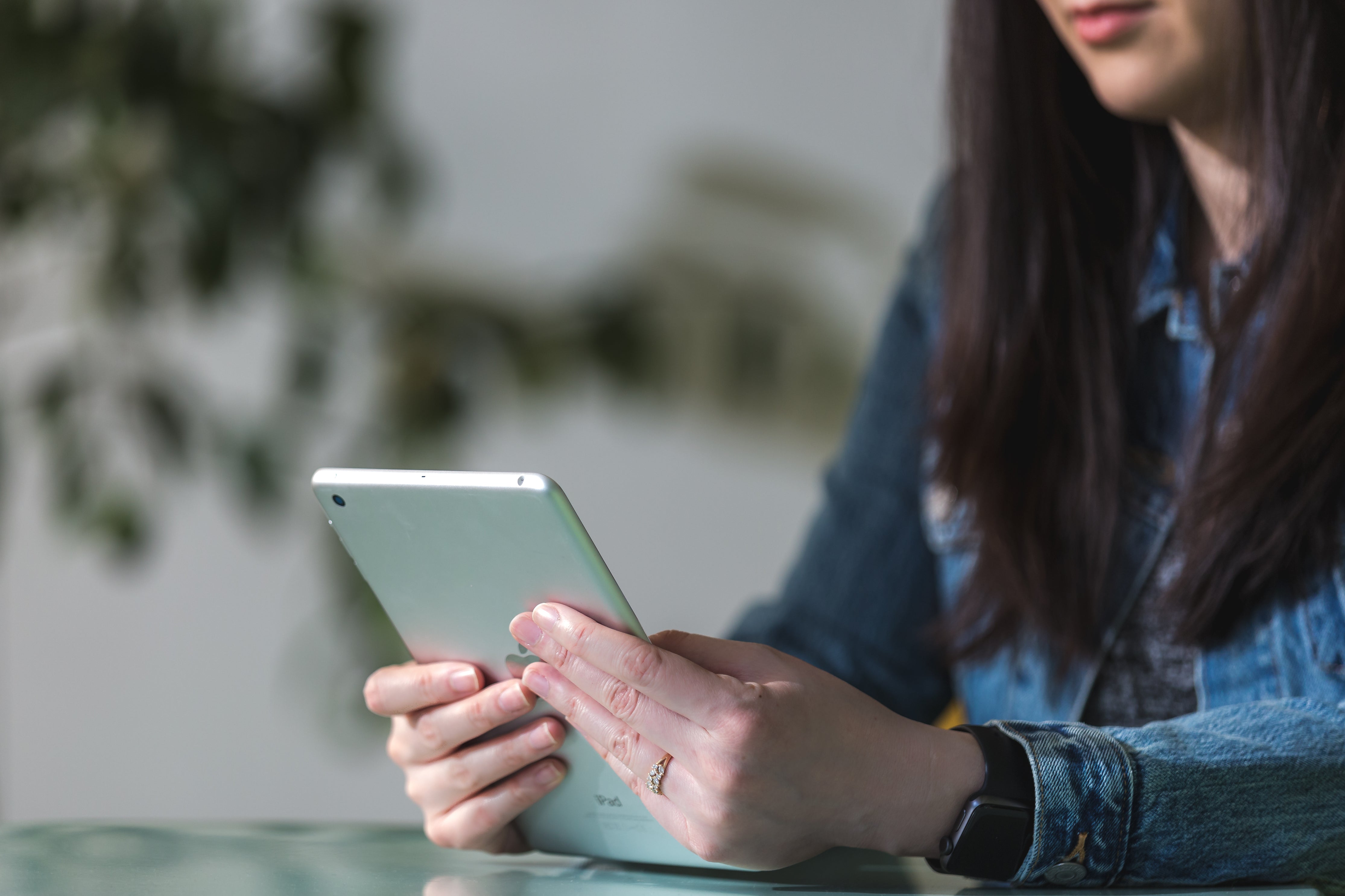 Person using a smartphone near a work desk