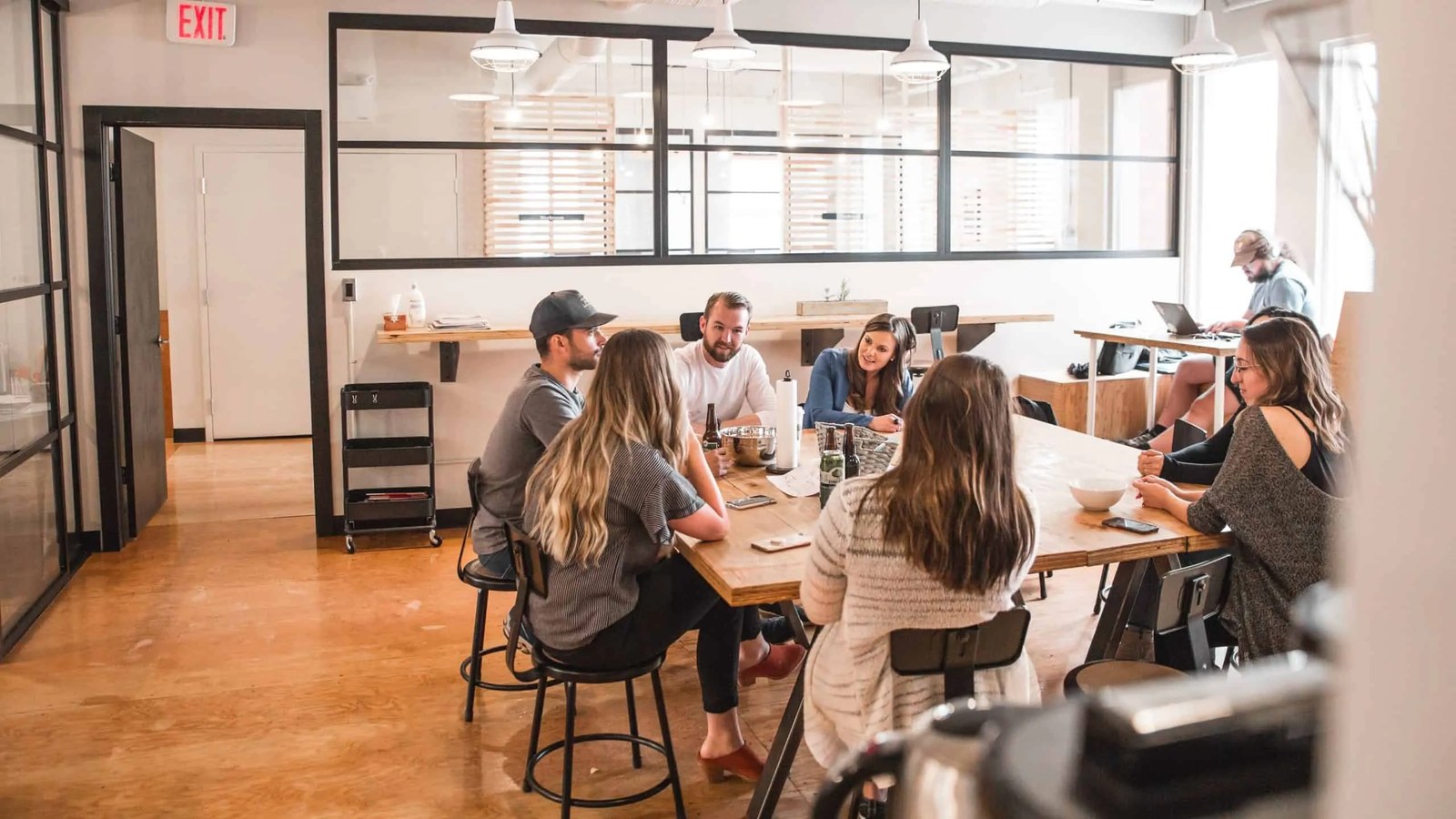 Team seated around a conference table in a glass meeting room